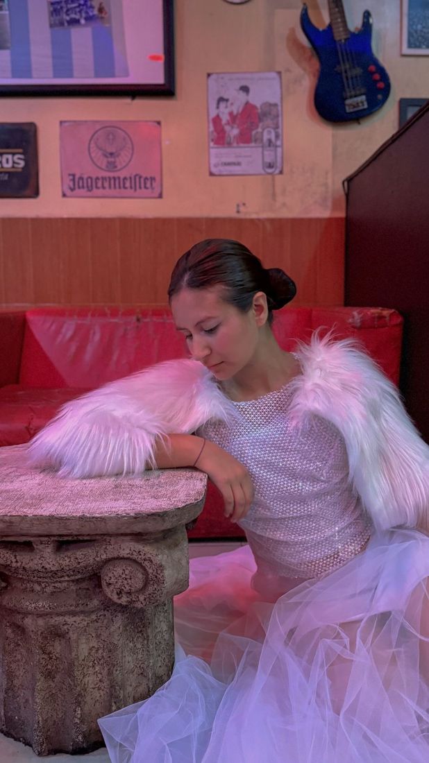 Look blanco apoyado en una columna